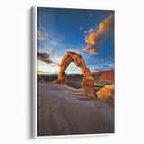 Framed canvas artwork showcasing a serene desert landscape, featuring warm tones of orange and brown with a white frame, ideal for home decor.