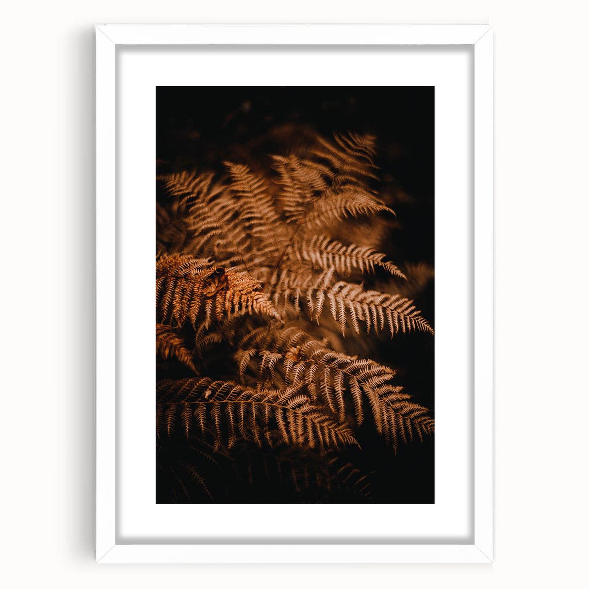 Abstract art print depicting fall colors in muted oranges and browns on a white framed canvas.