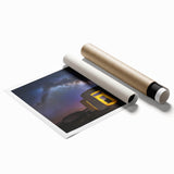 Scenic landscape print showcasing a majestic castle surrounded by lush greenery and a vibrant blue sky, rolled for easy shipping and display. Ideal for home decor enthusiasts.