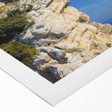 Vibrant rolled canvas artwork depicting a dramatic cliff landscape with rich colors and textures, ideal for home decor or office enhancement.