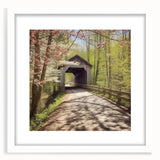Abstract art print of a covered bridge in muted gray tones on a framed white mat, ideal for bedroom or dining room decor.