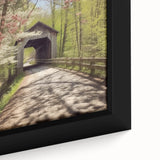 Close-up of a black framed canvas featuring a colorful, textured depiction of a covered bridge, ideal for living room decor.