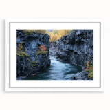 Landscape artwork featuring a canyon scene, framed with a white mat, showcasing vibrant earthy tones and intricate details, ideal for home decor.