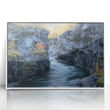 Framed acrylic artwork showcasing a stunning landscape of canyons with vibrant colors, mounted in a sleek white frame, perfect for modern home decor.