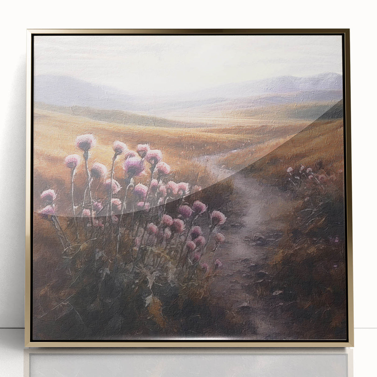 Framed wall art depicting a serene landscape of rolling hills and lush greenery, accented by a gold border, ideal for enhancing home decor with a touch of nature.