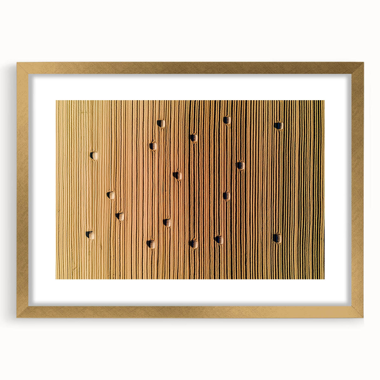 Elegant gold-framed landscape artwork featuring a serene countryside scene, complete with a white mat, ideal for enhancing home decor with a touch of sophistication.