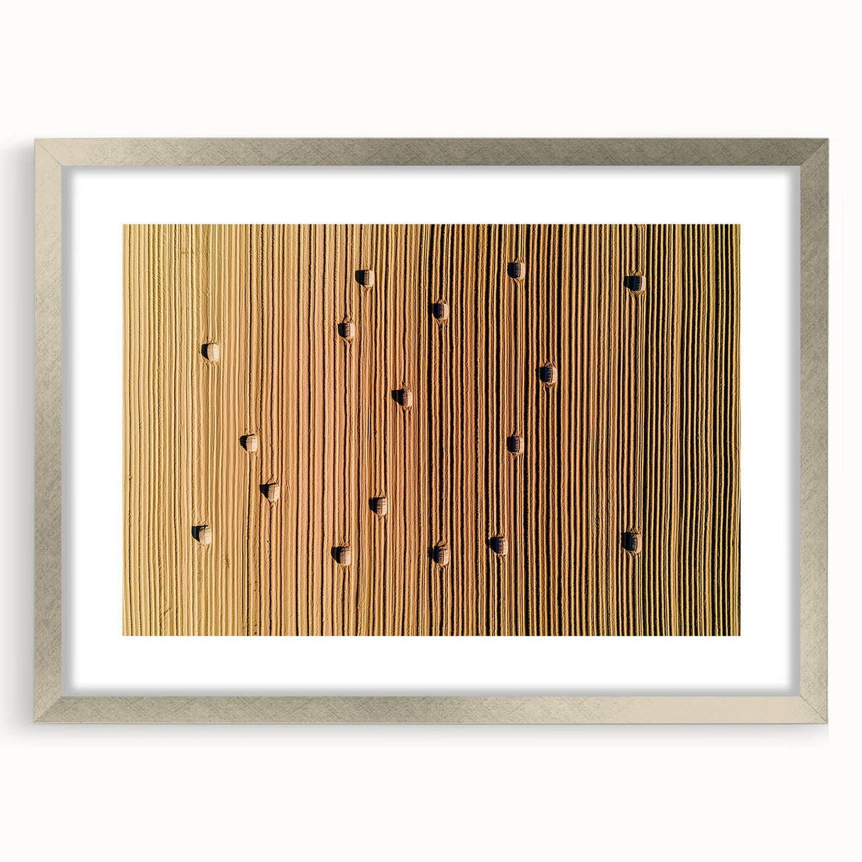 Silver-framed landscape artwork showcasing serene countryside scenery, elegantly matted for added depth, perfect for enhancing home decor with a rustic charm.