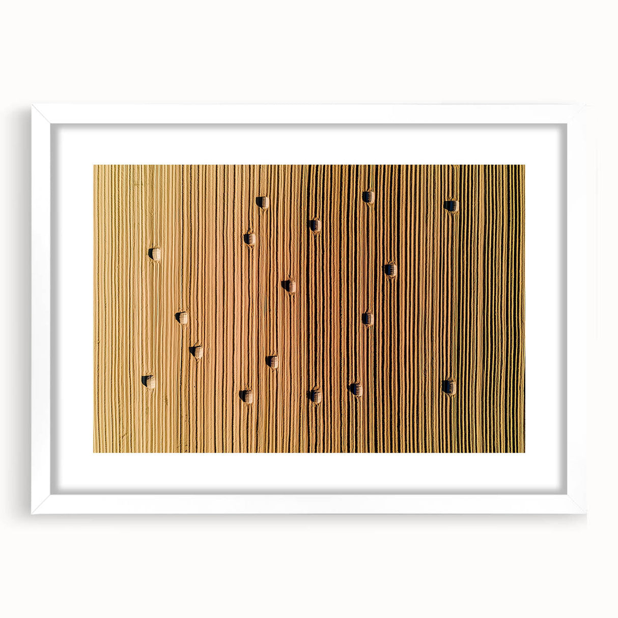 Scenic countryside landscape art framed in white matting, showcasing vibrant green fields and a clear blue sky, perfect for home decor or office aesthetics.