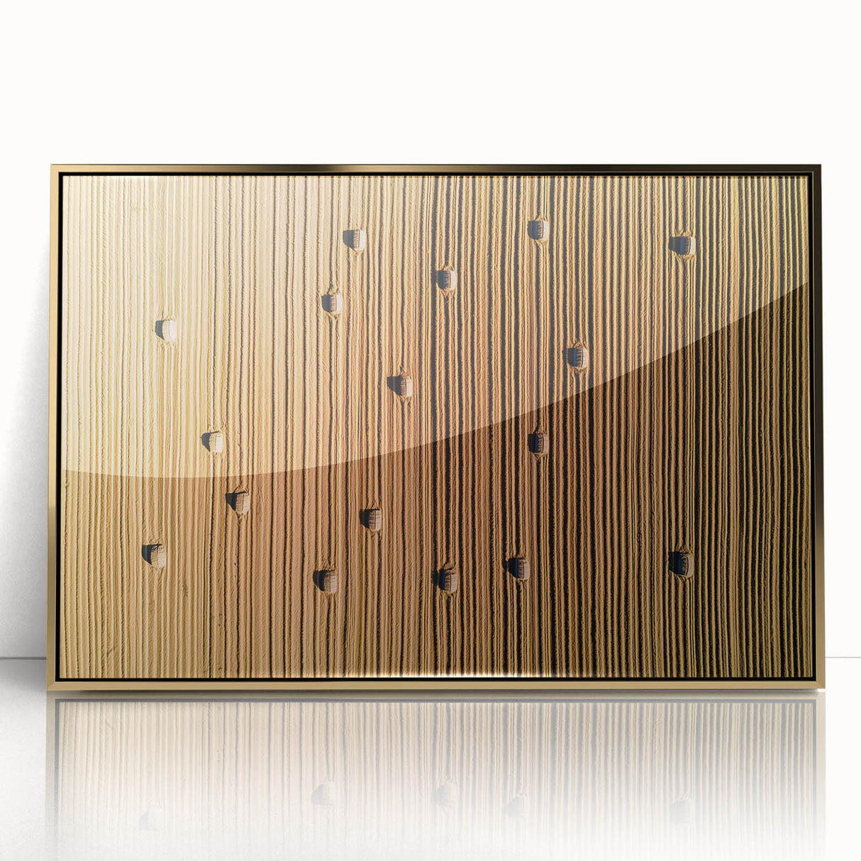 Framed acrylic artwork showcasing a serene countryside landscape with vibrant green fields and a tranquil sky, elegantly accented with a gold frame for a luxurious touch.