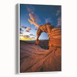 Framed canvas art depicting a serene desert landscape with warm earth tones, featuring cacti and mountains, showcased from a side view against a white background.