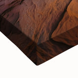 Close-up of a stretched canvas artwork depicting a vibrant desert landscape, showcasing rich hues of orange and tan with intricate textural details, ideal for home decor.