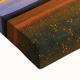 Close-up of a vibrant stretched canvas depicting a picturesque landscape with lush green fields under a bright blue sky, ideal for home decor.