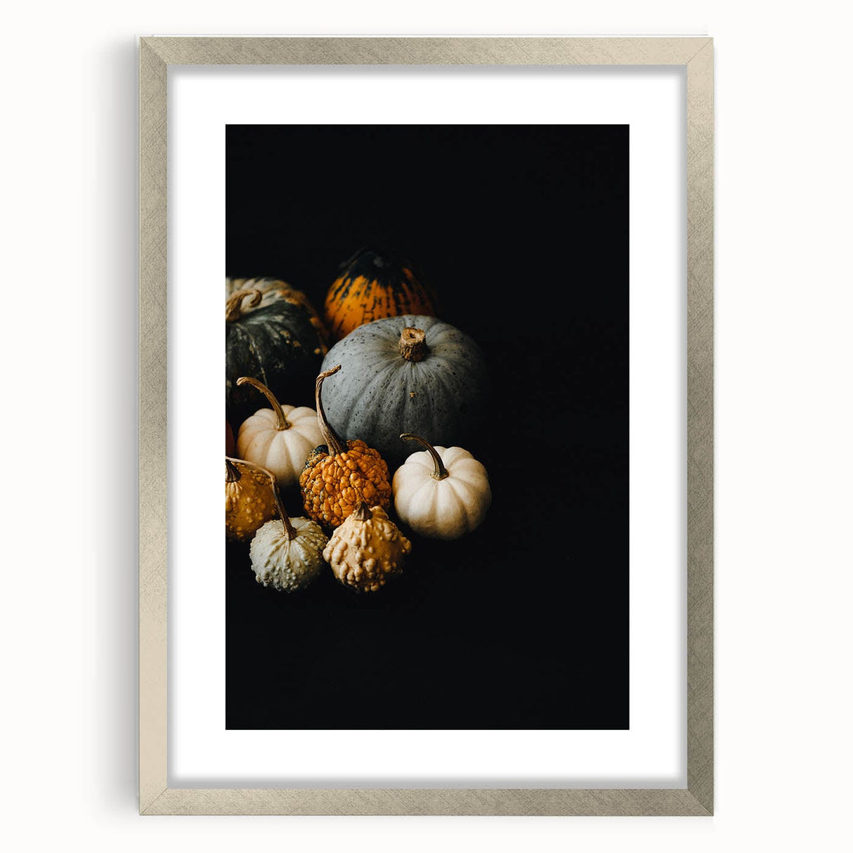 Textured abstract art print depicting autumnal hues on a silver-framed mat, suitable for bedroom decor.