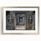 Framed landscape artwork depicting a majestic castle surrounded by lush greenery, set in a silver-colored mat, enhancing its elegant presentation for home decor.