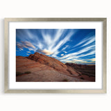 Framed landscape artwork showcasing rugged cliffs and serene ocean waves, elegantly displayed with a silver mat border, ideal for home decor enhancement.