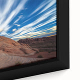 Close-up of a framed canvas depicting a stunning landscape of rugged cliffs under a vibrant blue sky, showcasing intricate details and textures ideal for home decor.