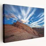 Stretched canvas artwork depicting a dramatic cliff landscape in warm hues, showcasing the intricate textures and details of nature's beauty, perfect for home decor.