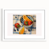 Abstract art print featuring assorted fruits in pastel shades, framed with a white mat, suitable for dining room decor.
