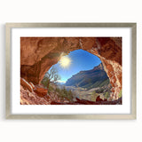 Framed landscape artwork depicting a serene desert scene, featuring warm earth tones and a sleek silver mat, ideal for home or office decor.