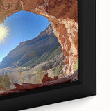 Close-up of a framed canvas artwork depicting a vibrant desert landscape with warm hues of orange and yellow, showcasing intricate details of the natural scenery. Ideal for home decor enthusiasts seeking unique wall art that brings a touch of nature indoors.