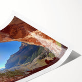 Desert landscape rolled canvas print showcasing vibrant hues of orange and yellow under a blue sky, elegantly packaged in a protective cardboard tube for shipping.