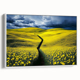 Framed canvas artwork showcasing a serene landscape of lush green fields under a bright blue sky, elegantly displayed from the side view with a white frame, perfect for home decor.
