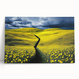 Stretched canvas artwork depicting a serene landscape with vibrant green fields and a clear blue sky, leaning against a wall, perfect for home decor.