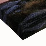 Close-up of a stretched canvas showcasing a vibrant landscape with a majestic castle, rich colors, and fine detailing, perfect for home decor.