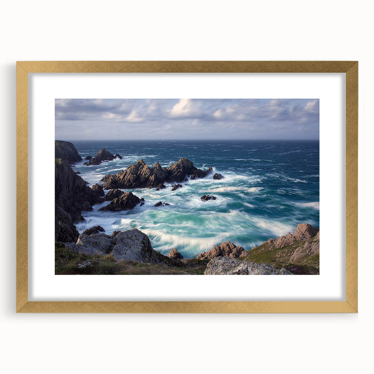 Framed landscape art featuring cliffs and a vibrant sky, elegantly displayed with a gold mat, perfect for enhancing home decor aesthetics.