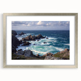 Framed landscape artwork showcasing dramatic cliffs in silver matting, ideal for home decor, emphasizing nature's beauty with vibrant colors and intricate details.