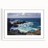 Framed landscape artwork showcasing dramatic cliffs and serene blue skies, presented with a white mat for an elegant finish, ideal for modern home decor.