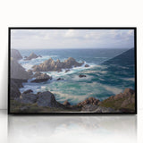 Framed acrylic artwork depicting dramatic cliffs against a vibrant sunset, showcasing rich colors and textures in a sleek black frame, ideal for modern decor.