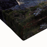 Close-up of a stretched canvas showcasing a dramatic landscape with towering cliffs and vibrant colors, perfect for modern home decor and wall art enthusiasts.