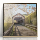 Large abstract wall art depicting a covered bridge in muted gold tones on a framed acrylic.