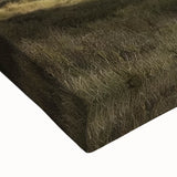 Close-up of a stretched canvas print depicting a vibrant landscape scene of a rustic barn under a clear blue sky, featuring rich colors and detailed textures, ideal for home decor.