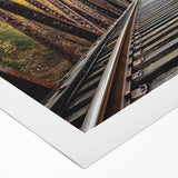 Rolled canvas showcasing a vibrant landscape bridge design with rich colors and intricate details, ideal for home decor, shipped securely in a protective tube.