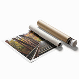 Rolled print showcasing a vibrant landscape bridge design, featuring rich colors and intricate details, securely packaged in a protective cardboard tube for safe delivery.