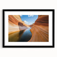 Black-framed landscape artwork showcasing a stunning canyon view, complete with a white mat for added elegance, perfect for home décor or art collection.