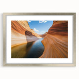 Framed landscape artwork depicting stunning canyons in rich earth tones, featuring a silver mat border that enhances the visual appeal, perfect for home decor.