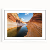 Landscape art print of colorful canyons framed with a white mat, showcasing vibrant earth tones and intricate textures, perfect for home décor enhancement.