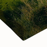 Close-up of a stretched canvas featuring a serene countryside landscape, showcasing vibrant greens and blues with textured brush strokes, ideal for home decor.