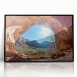 Framed acrylic artwork showcasing a vibrant desert landscape, featuring warm hues of orange and brown, set in a sleek black frame for modern decor.