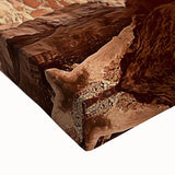 Close-up of a stretched canvas artwork depicting a vibrant desert landscape, featuring warm tones of orange and yellow with detailed textures, ideal for home decor.