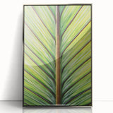 Mid-century modernist art depicting a close-up floral design in muted pastels on a silver-framed acrylic.