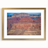 Framed landscape artwork depicting majestic canyons, featuring a gold mat and stylish frame, perfect for enhancing modern home decor and adding elegance to any room.
