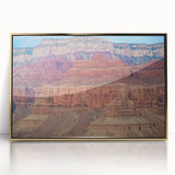 Framed acrylic artwork showcasing a stunning landscape of colorful canyons, featuring rich gold accents, designed to enhance modern decor with vibrant hues and depth.