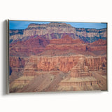 Framed landscape canvas artwork showcasing a stunning view of canyons, with a sleek silver frame enhancing its aesthetic appeal, ideal for home decor.