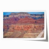 Stunning landscape print of vibrant canyons showcasing rich earthy tones and intricate textures, rolled and ready for display in a sturdy protective tube.