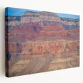 Stretched canvas artwork depicting a stunning landscape of canyons with vibrant colors, showcasing intricate details and textures, perfect for enhancing home decor.