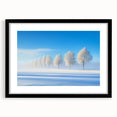 Black-framed landscape artwork featuring a picturesque countryside scene with lush green fields and a bright blue sky, elegantly matted to enhance its beauty.